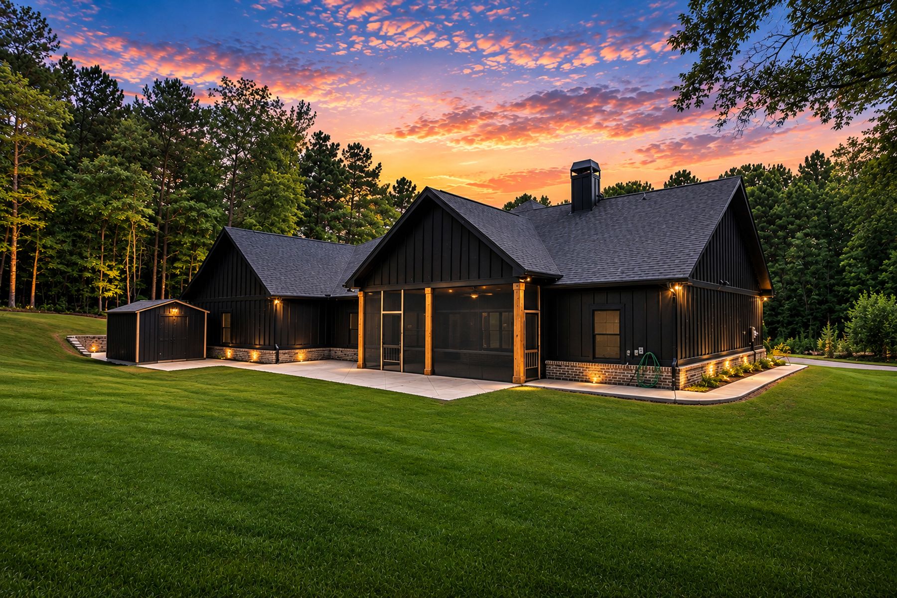 Rear elevation at twilight with level lawn