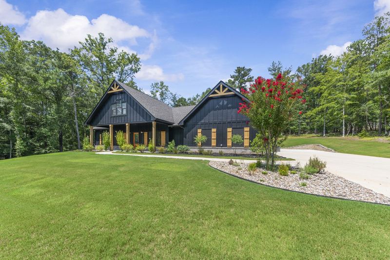 Front of home with landscaped beds and lawn