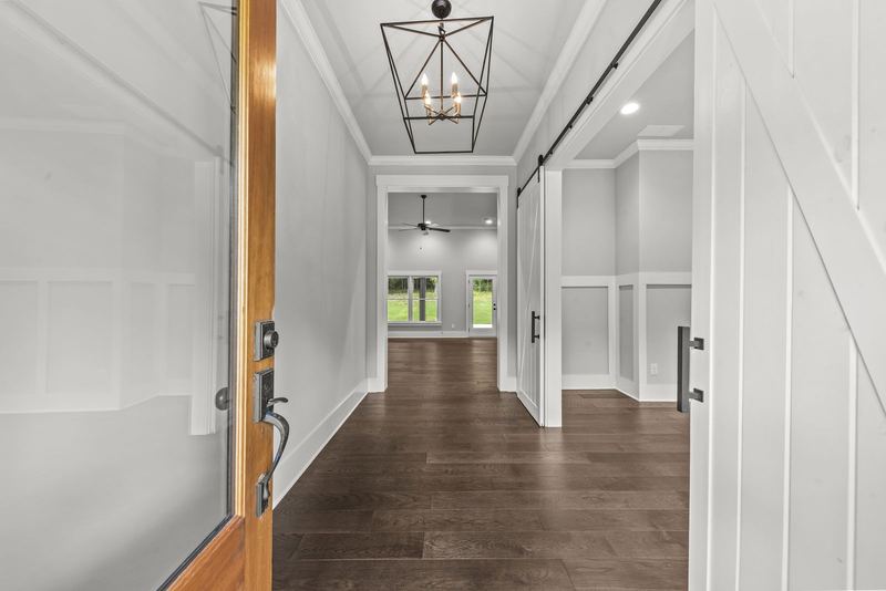 Entrance foyer with glass front door and sliding barn doors