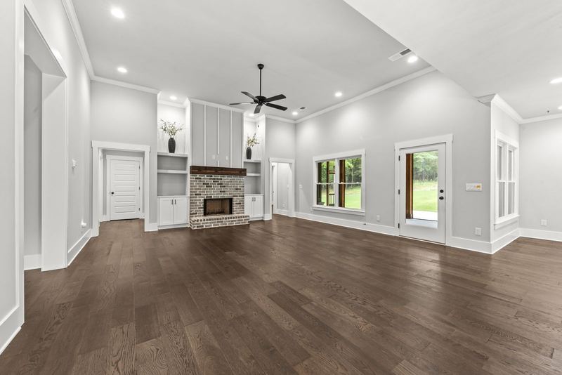 Great room with fireplace and open flow to kitchen