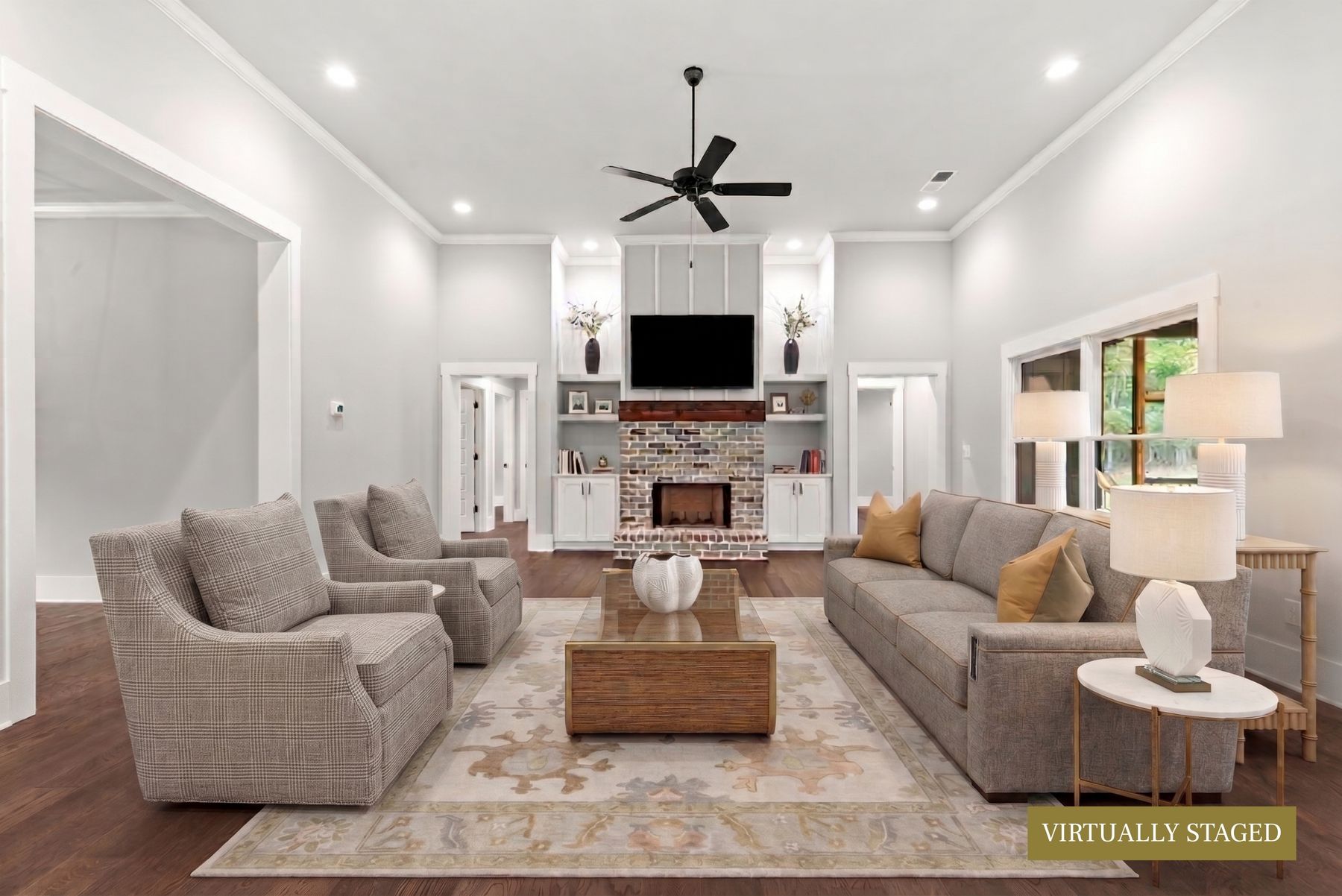 Great room with vaulted ceiling, brick fireplace and custom built-in shelving