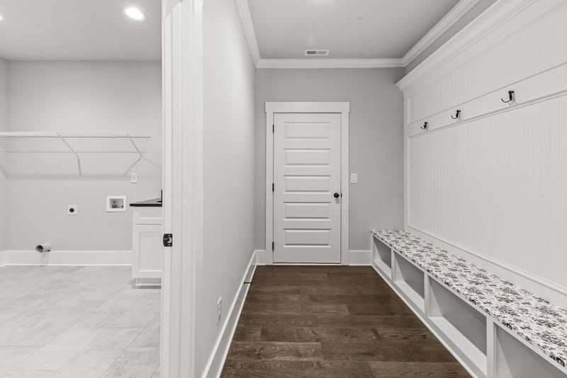 Mud room with built-in bench and shelving