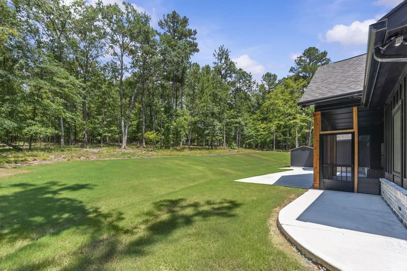 Level backyard framed by trees