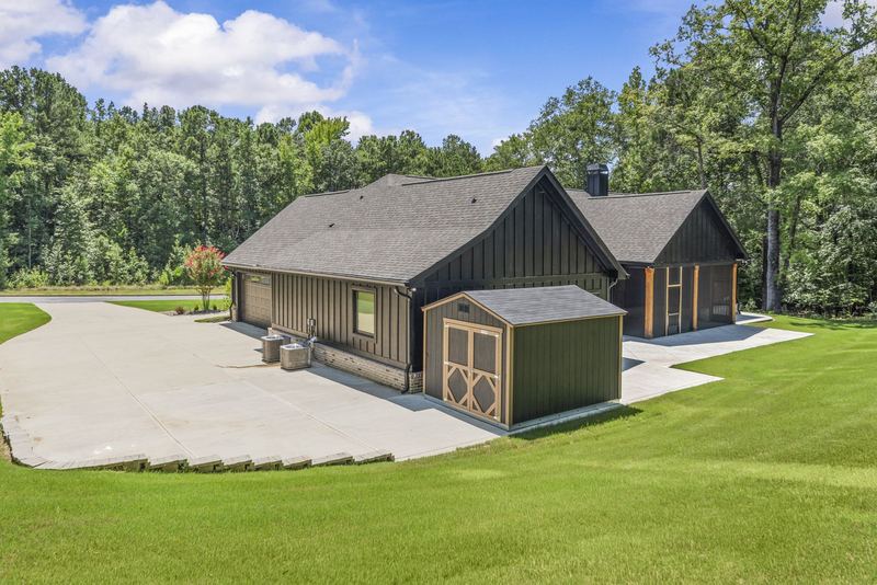 Rear of home with storage shed